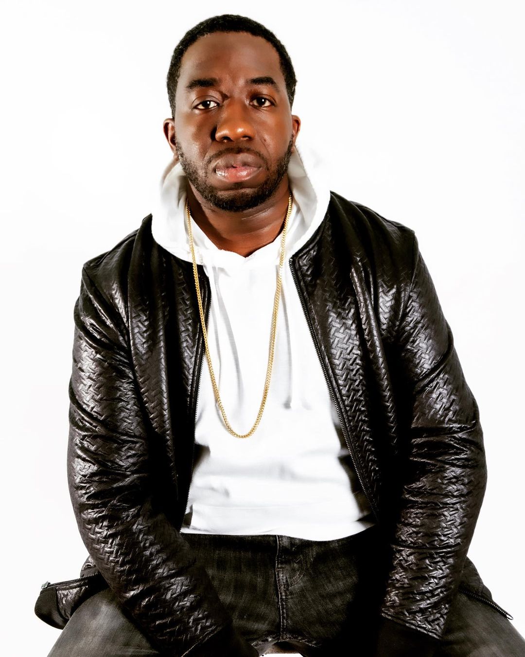 DJ WESWILL wearing a black leather jacket over a white hoodie.